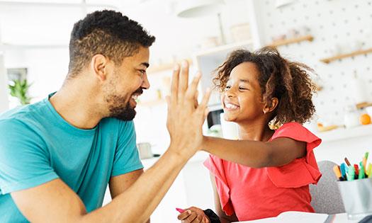 Caregiver and child talking together at home, showing collaborative goal setting for parents and kids